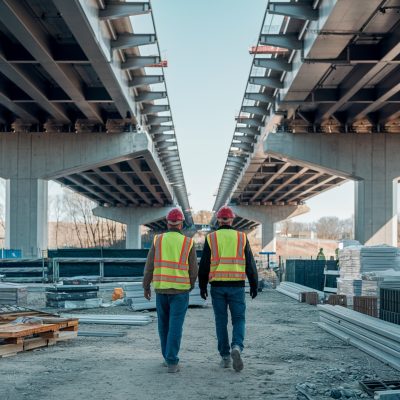 vecteezy_workers-in-red-hard-hats-and-yellow-vests-walk-on_53745843